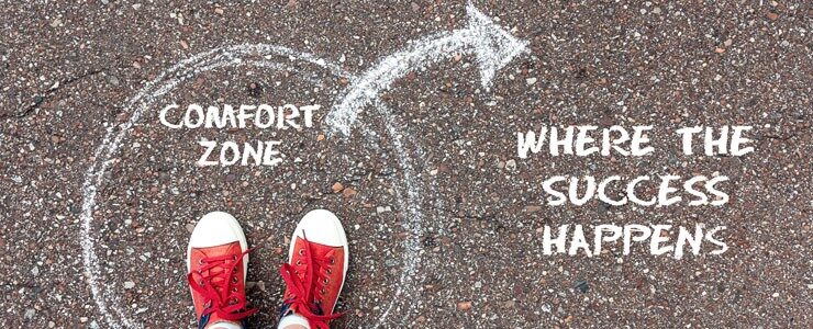 How can one live a purposeful life by breaking free from their comfort zone?