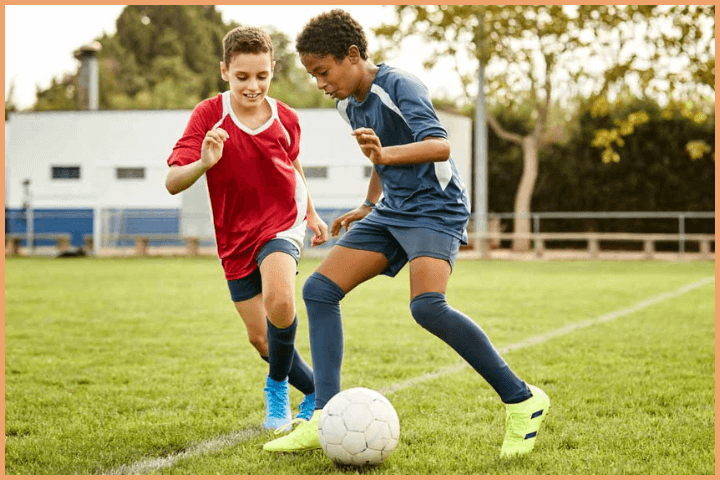 Two boys playing football